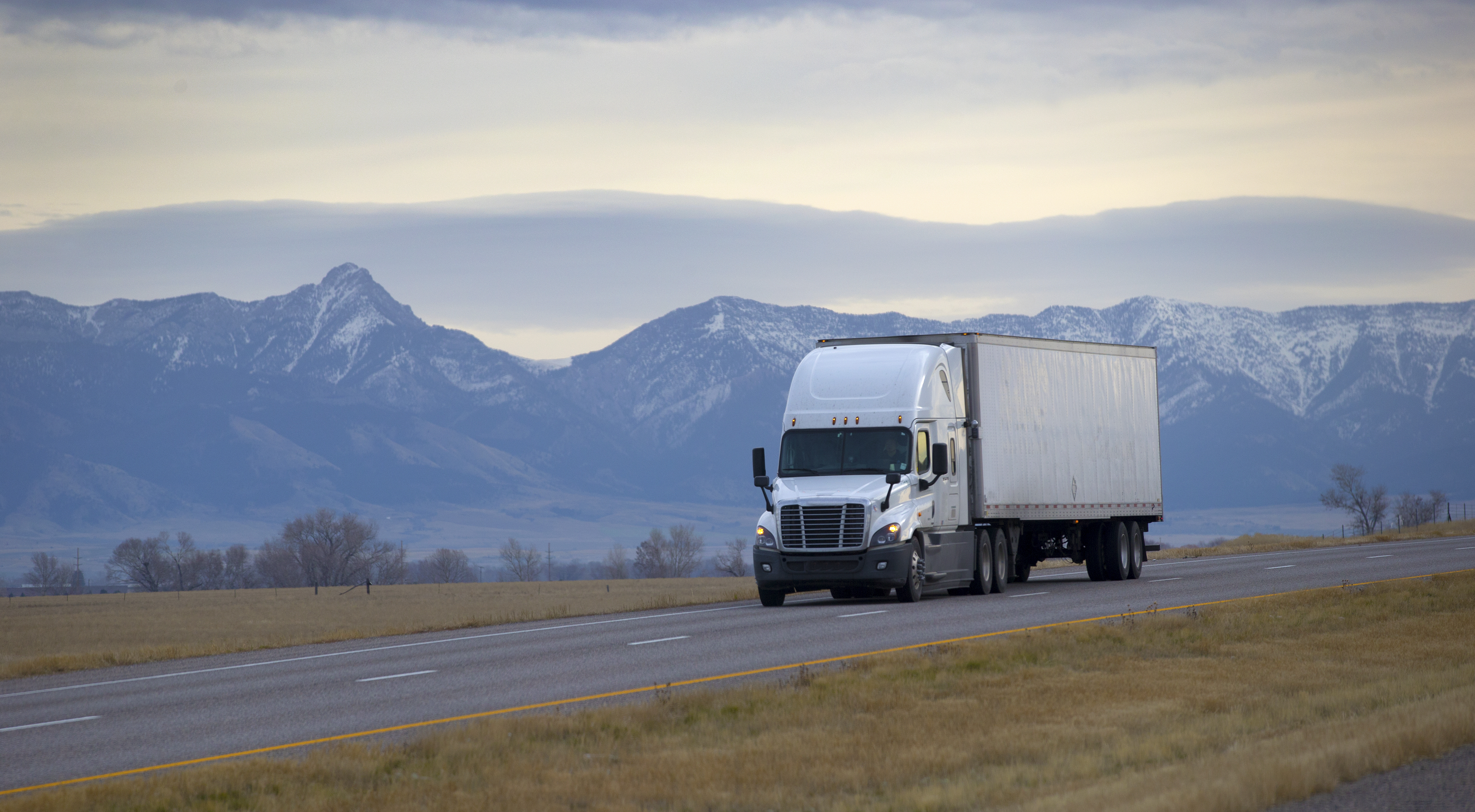 SEMI TRUCK DRIVING ON MOUNTAIN HIGHWAY,  MONTANA - DECEMBER 10, 2016: Semi truck driving on mountain highway 